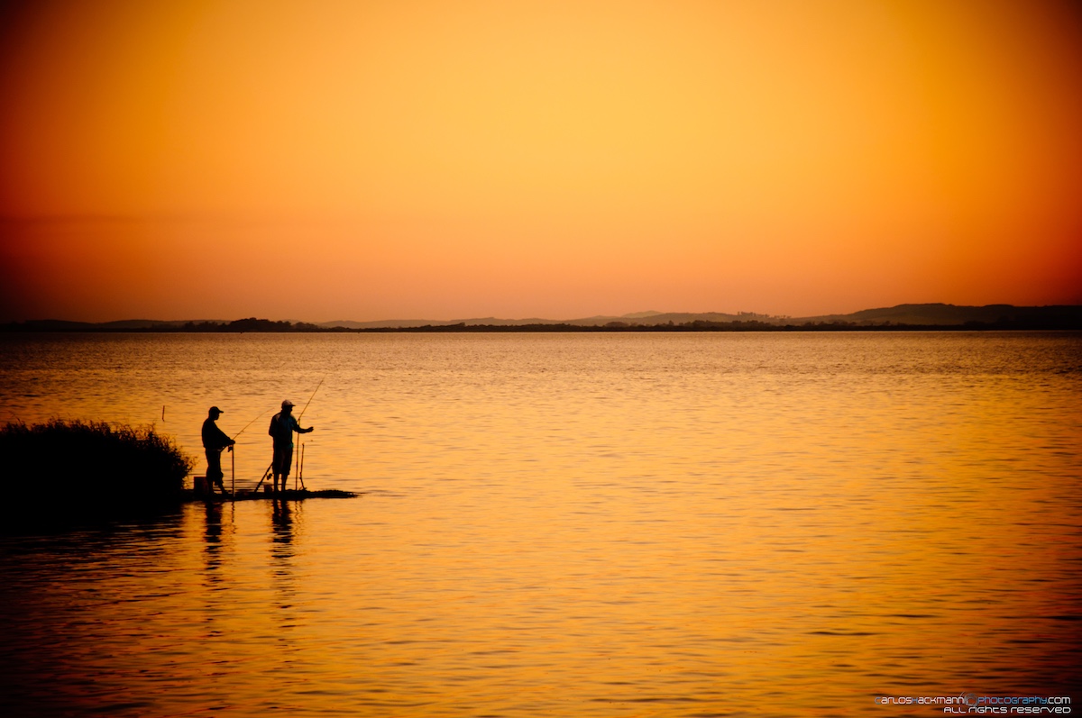 beautiful landscape of a fishery on the lake during sunset