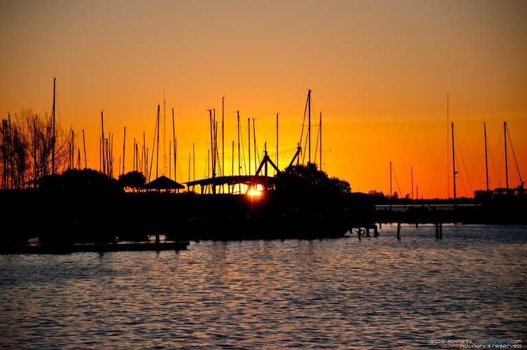 sunset at yachtie club with boats silhouettes