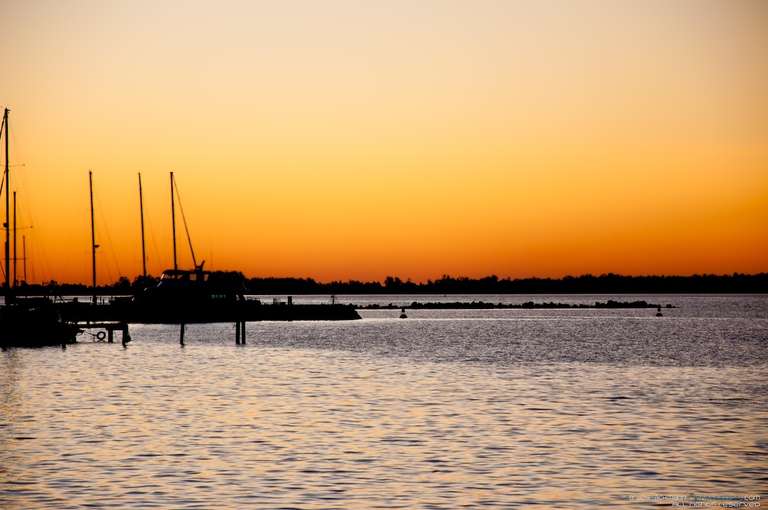 sunset at yachtie club with boats silhouettes