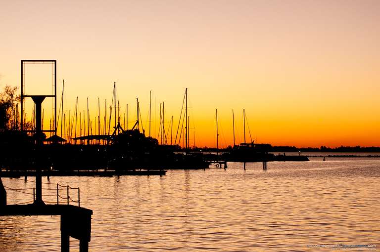 sunset at yachtie club with boats silhouettes