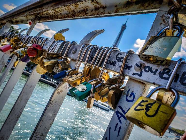 attached padlocks (love locks) to the railing or the grate on the side of the bridge as a romantic gesture